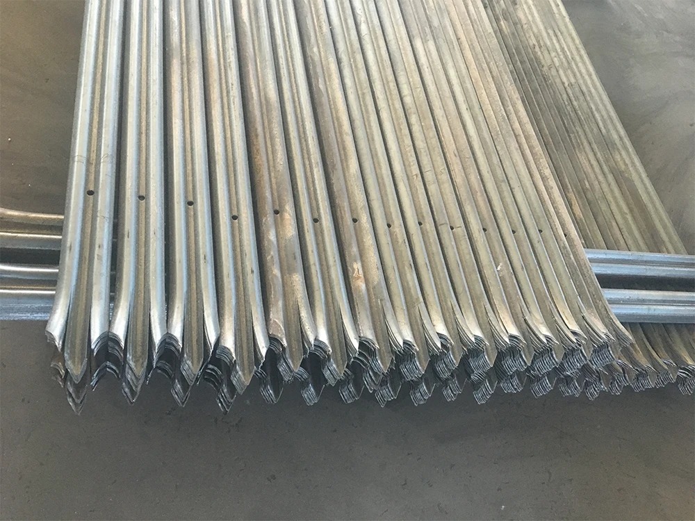 Stacked galvanised palisade pales with fixing holes